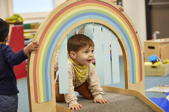 Toddler in Rainbow arch