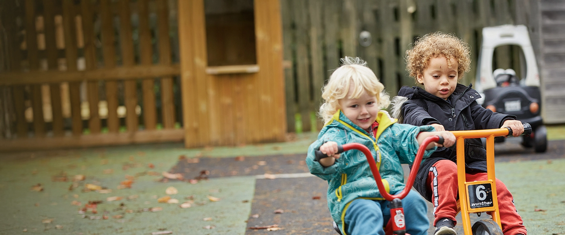 2 children riding trikes