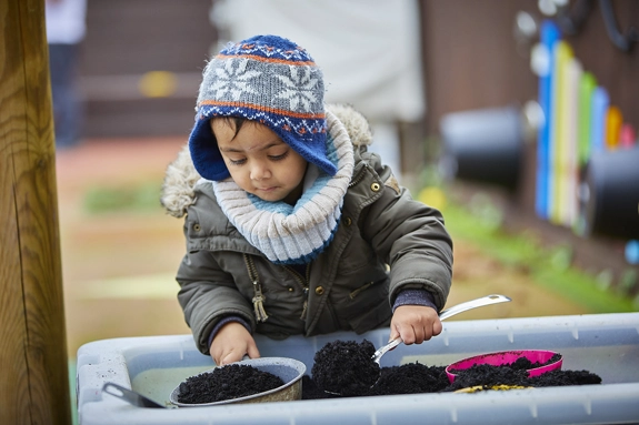 Child playing in a garden