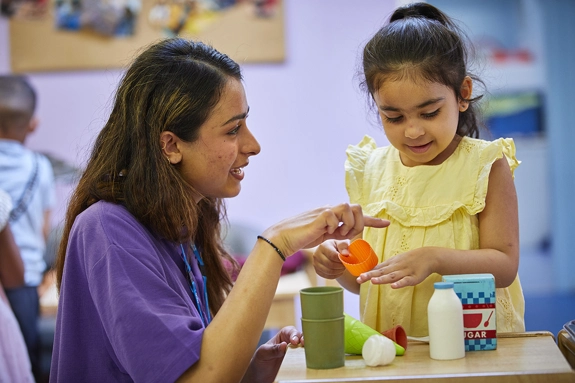 Nursery Staff playing with Girl
